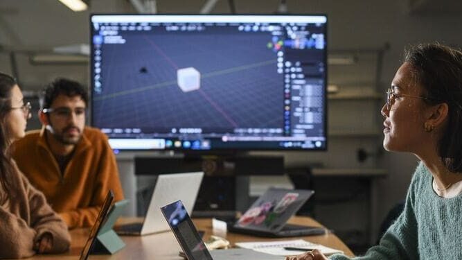 Image of people talking with a large screen in the background