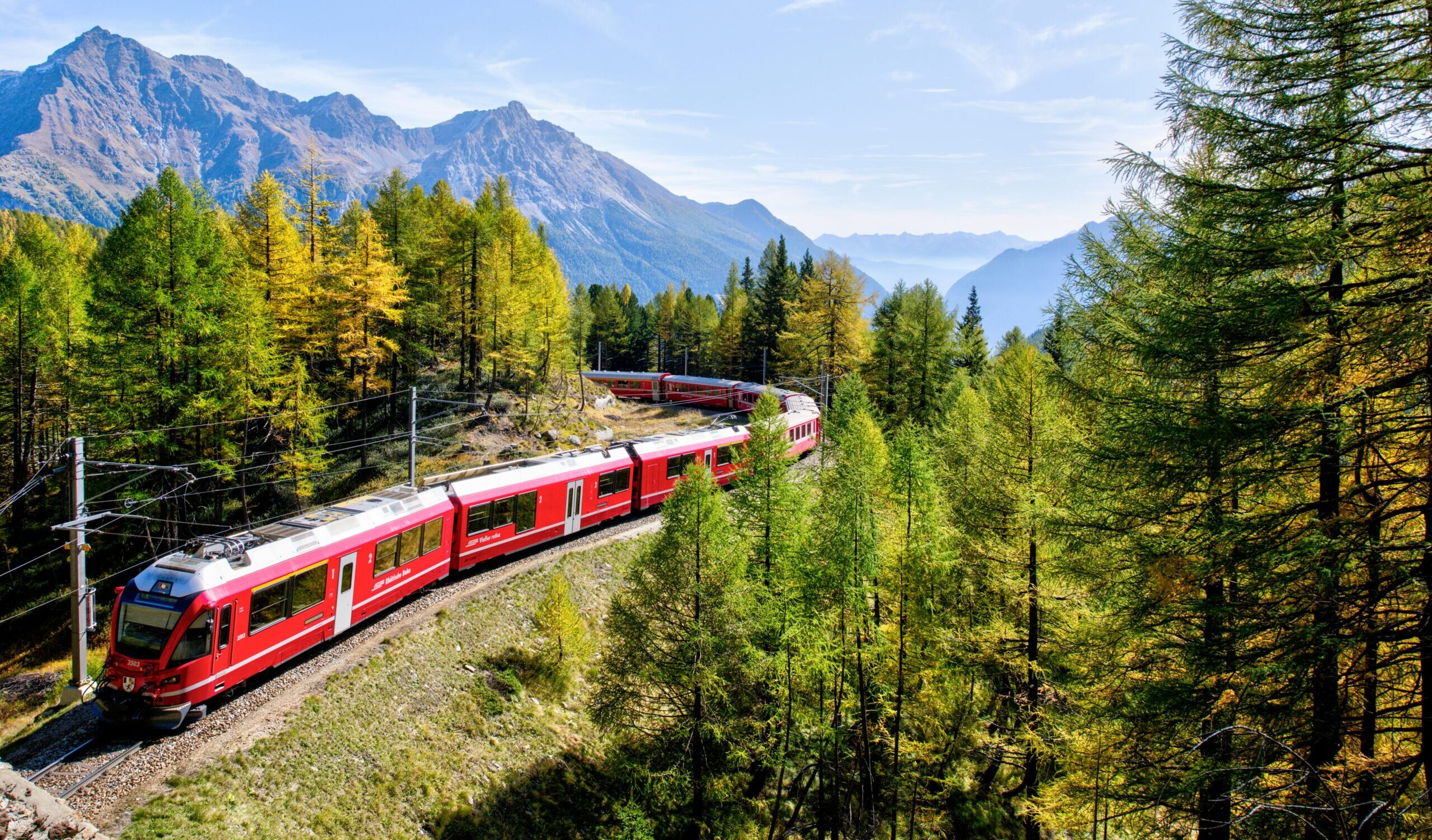 A train cuts through the Swiss mountains